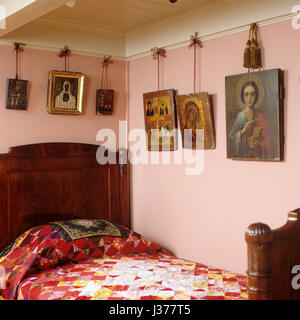 Pink bedroom decorated with religious art. Stock Photo