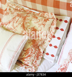 Assorted red and white bed linen. Stock Photo