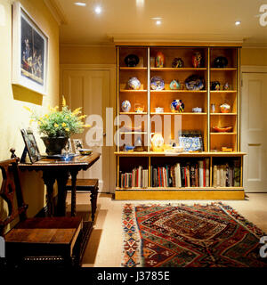 Bookshelf with patterned rug. Stock Photo