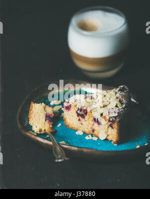 Piece of lemon, ricotta, almond, raspberry cake and latte Stock Photo