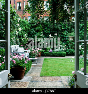 Back garden with bench. Stock Photo