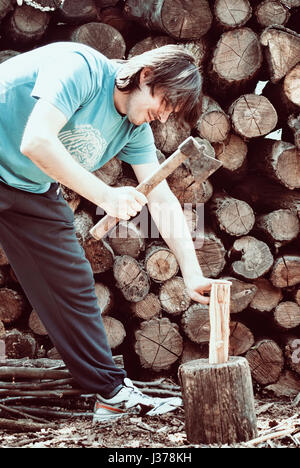 Man choping woods in the yard Stock Photo