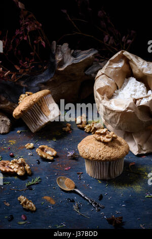 Brown walnut cupcakes with ingredients. Close up. Stock Photo