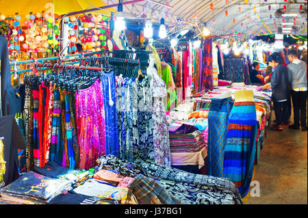 Woman dresses and t-shorts and pants for sell at night market. Chiang Mai, Thailand Stock Photo