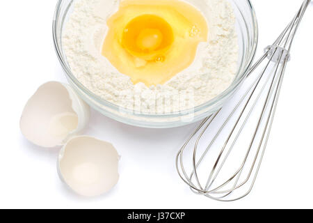 Flour with egg in glass bowl Stock Photo