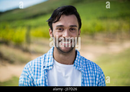 Portrait of smiling man with vineyard in background Stock Photo