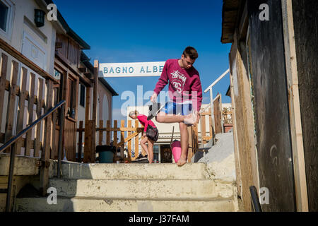 MARINA DI PISA, ITALY - Avril 24, 2017: People clean their feet from the sand in Marina di Pisa, Tuscany Stock Photo