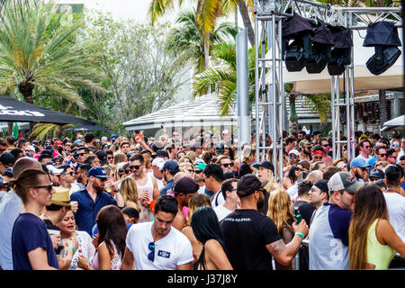 Miami Beach Florida,Miami Music Week,hotel pool party,crowd,standing,dancing,drink drinks beverage beverages drinking,young adult,men,women,stage,ligh Stock Photo