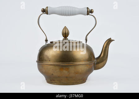 Old and antique vintage copper coffee pot on isolated white background Stock Photo