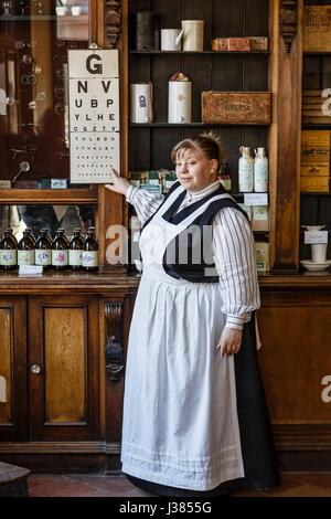 An actor at Blists Hill Victorian Museum poses as a pharmacist in a traditional apothecary. Ironbridge, UK Stock Photo