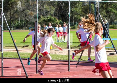 Primary school australian children participating in their primary school 100m sprint dip at the finish line annual athletics events,Sydney,Australia Stock Photo