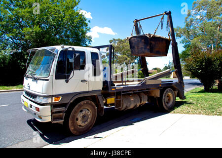 Truck loading garbage skip Stock Photo - Alamy