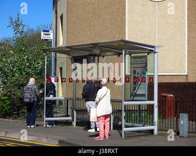 People waiting at bus stop in Possilpark Glasgow Stock Photo