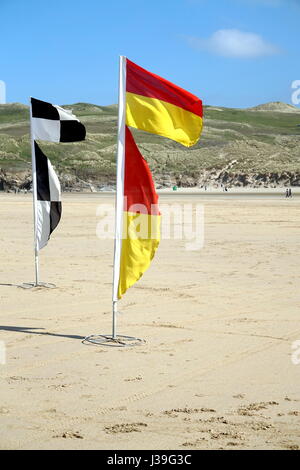 Newquay, Cornwall, UK - April 7 2017: Warning flags on the beach for swimmers and surfers Stock Photo
