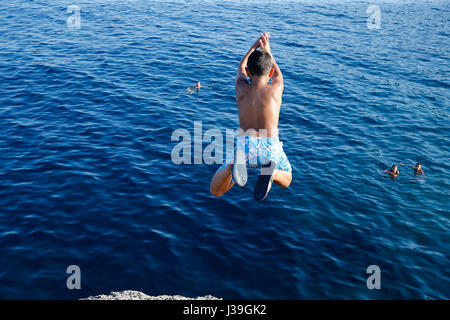 9-year-old boy diving into the sea. Stock Photo