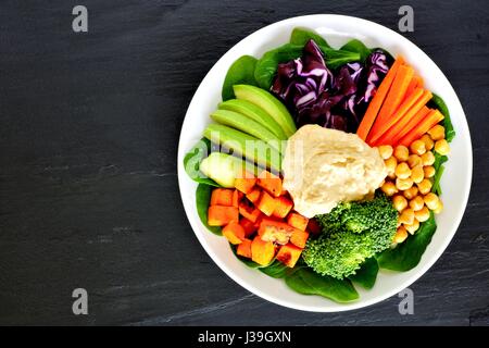 Healthy nourishment bowl with super-foods and fresh mixed vegetables, overhead view on dark slate Stock Photo