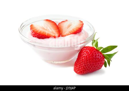 Clear bowl of strawberry flavored yogurt with fresh berries over a white background Stock Photo