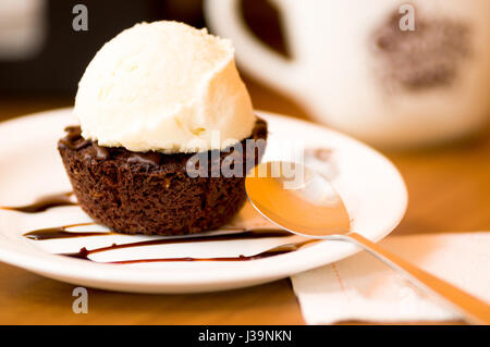 Close up of a delicious icecream on top of a brownie with a chocolate sauce in plate Stock Photo