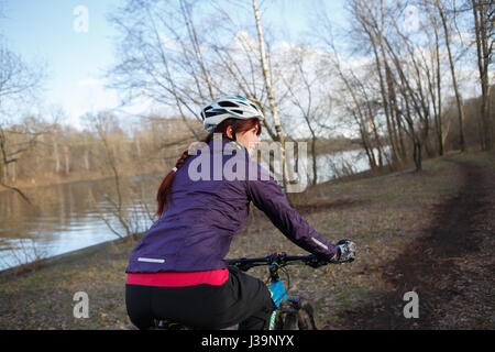 Girl rides bike at park Stock Photo