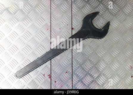 large metal key screw, on metal plate Stock Photo