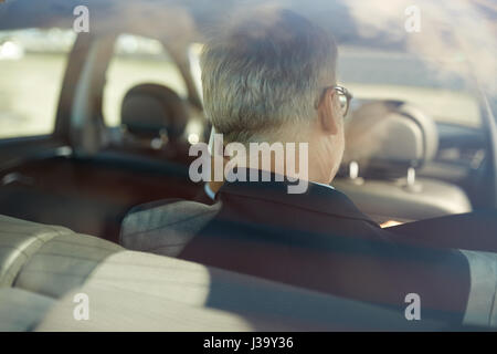 senior businessman calling on smartphone in car Stock Photo