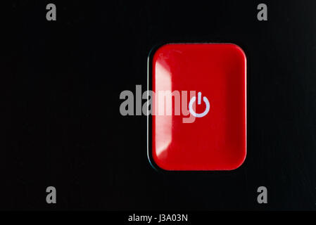 Red plastic rectangle power button with icon on black background Stock ...