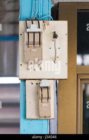 Old electrical power safety breaker with socket outlet on the wall Stock Photo