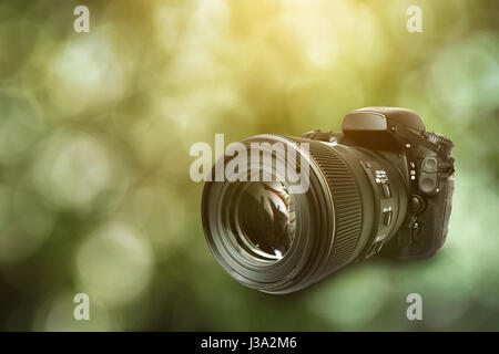 DSLR Camera on green background Stock Photo