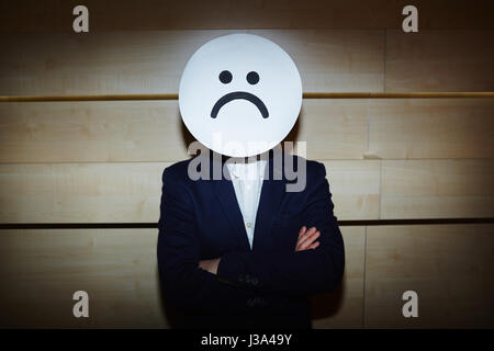 Businessman in Sad Mask Stock Photo