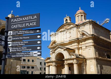 Castille Place signpost with St Catherine of Italy church to the rear in Castille Place, Valletta, Malta, Europe. Stock Photo