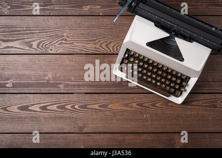 Old typewriter on wooden table. Top view Stock Photo
