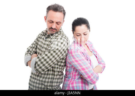 Sad couple standing to each other with folded arms as relationship problems concept isolated on white Stock Photo