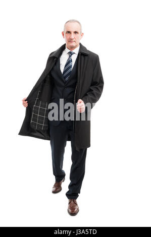 Full body of middle age business man posing wearing elegant raincoat isolated on white background Stock Photo