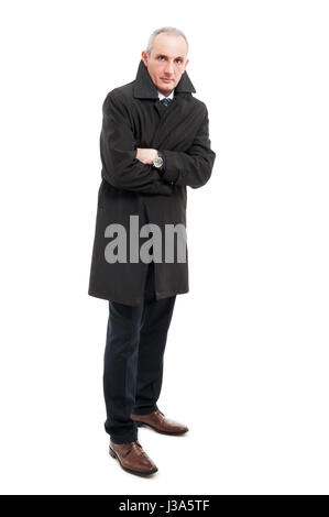 Full body of middle age man wearing raincoat with arms crossed looking cold isolated on white background Stock Photo