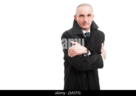 Middle age man wearing raincoat looking cold isolated on white background with copy text space Stock Photo