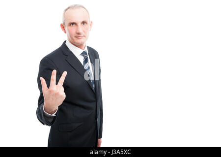 Portrait of aged elegant man showing number three gesture wearing suit and tie isolated on white background with copy text space Stock Photo