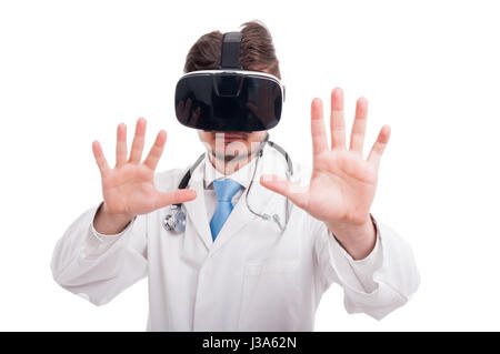 Handsome doctor with vr goggles touching futuristic screen on white studio background Stock Photo