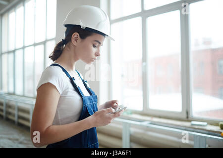 Woman Using Digital Device in Construction Stock Photo