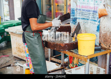 GEORGE TOWN, MALAYSIA - MARCH 23: Man prepare the fish for sale at the wet market on March 23, 2016 in George Town, Malaysia. Stock Photo