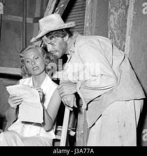 Michèle Morgan and Gérard Philipe on the set of the film 'Les Orgueilleux', directed by Yves Allégret and Rafael E. Portas in 1953. Stock Photo