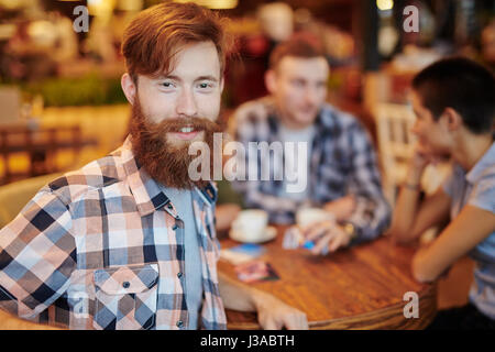 Having Coffee Break in Small Cafe Stock Photo