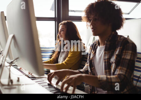 Audio engineers playing electric keyboard in recording studio Stock Photo