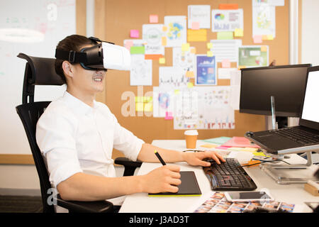 Designer using digitizer and VR glasses while working in office Stock Photo