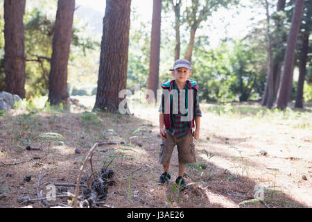 Portrait of boy wearing cap hiking in forest Stock Photo