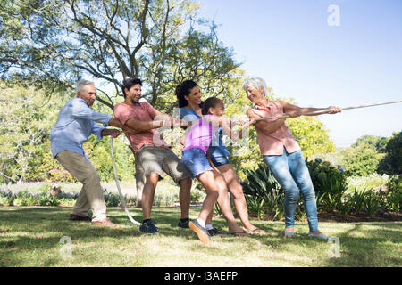 Family playing tug of war in a garden, Gurgaon, Haryana, India Stock ...