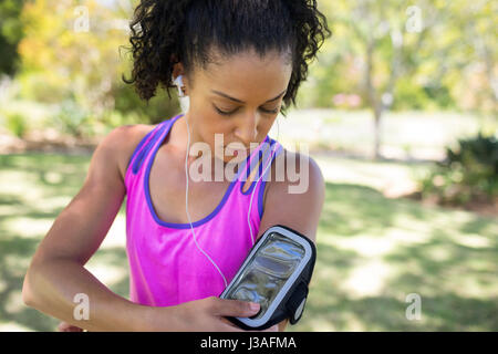 Close-up jogger woman touching the mp3 player in armband Stock Photo