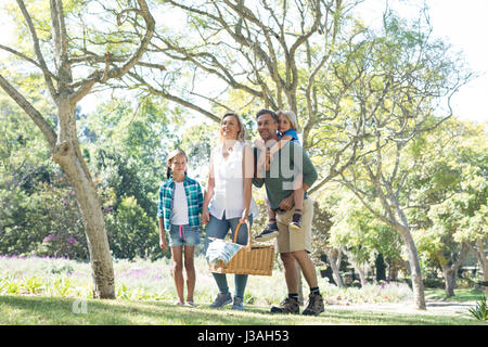 Family arriving in the park for picnic on a sunny day Stock Photo