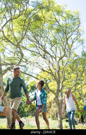 Family arriving in the park for picnic on a sunny day Stock Photo