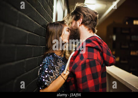 Young couple embracing on a balcony Stock Photo