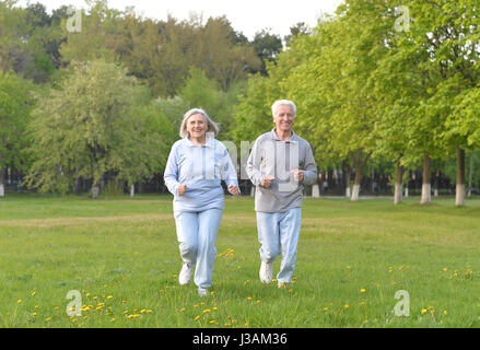 old couple is doing sports on nature Stock Photo